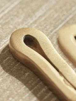 Four Small Brass Hooks